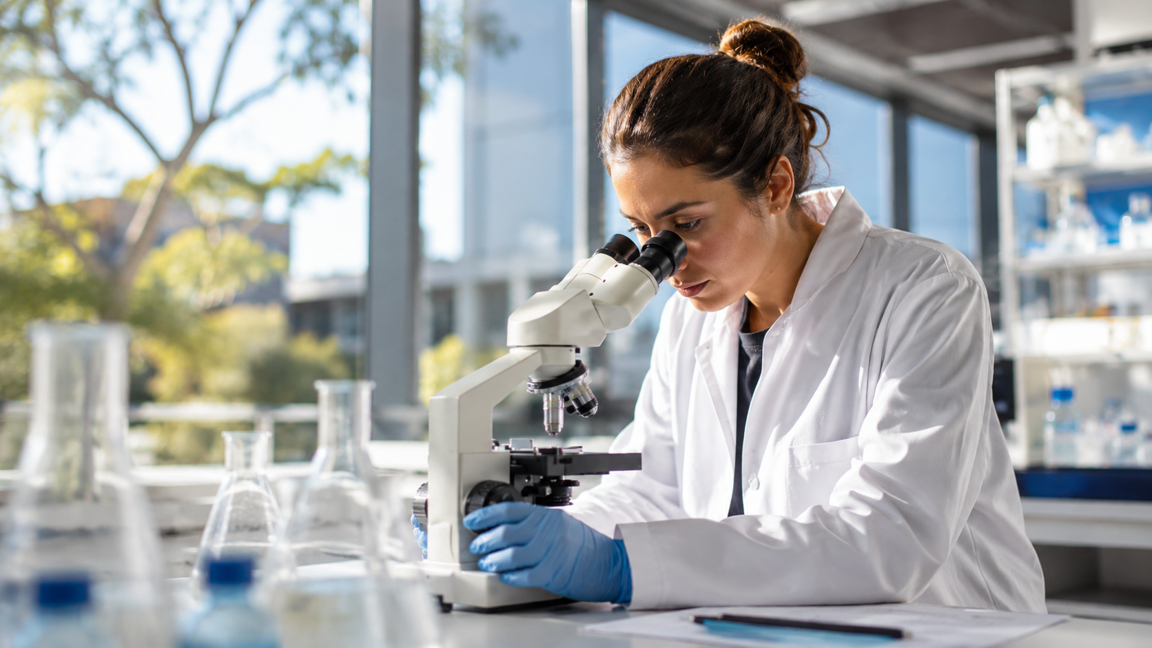 Researcher reviewing a documented sample under a microscope